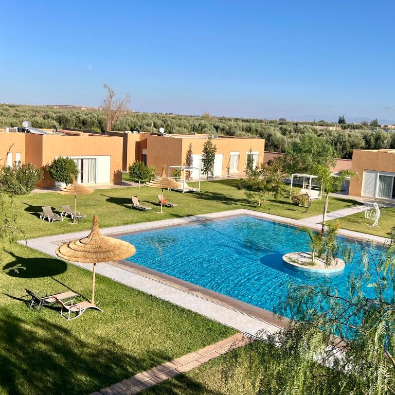 a swimming pool in the middle of a yard at Domaine Bahi - Marrakech in Marrakesh