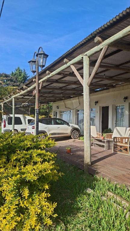 a wooden pergola with cars parked in a parking lot at La Liebre in Federación