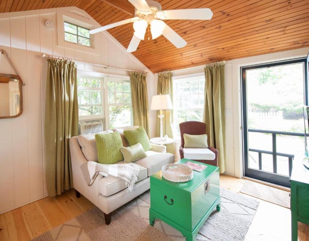 a living room with a couch and a ceiling fan at The Cottages at Cabot Cove in Kennebunkport
