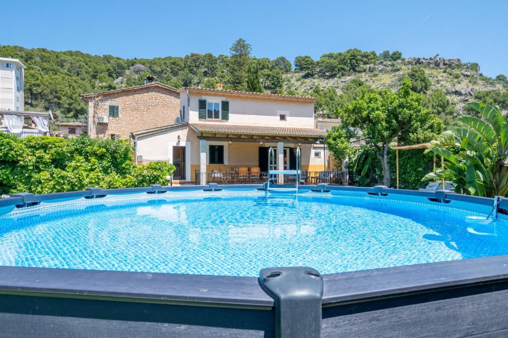 a large swimming pool in front of a house at Can Freixa - Sóller in Sóller