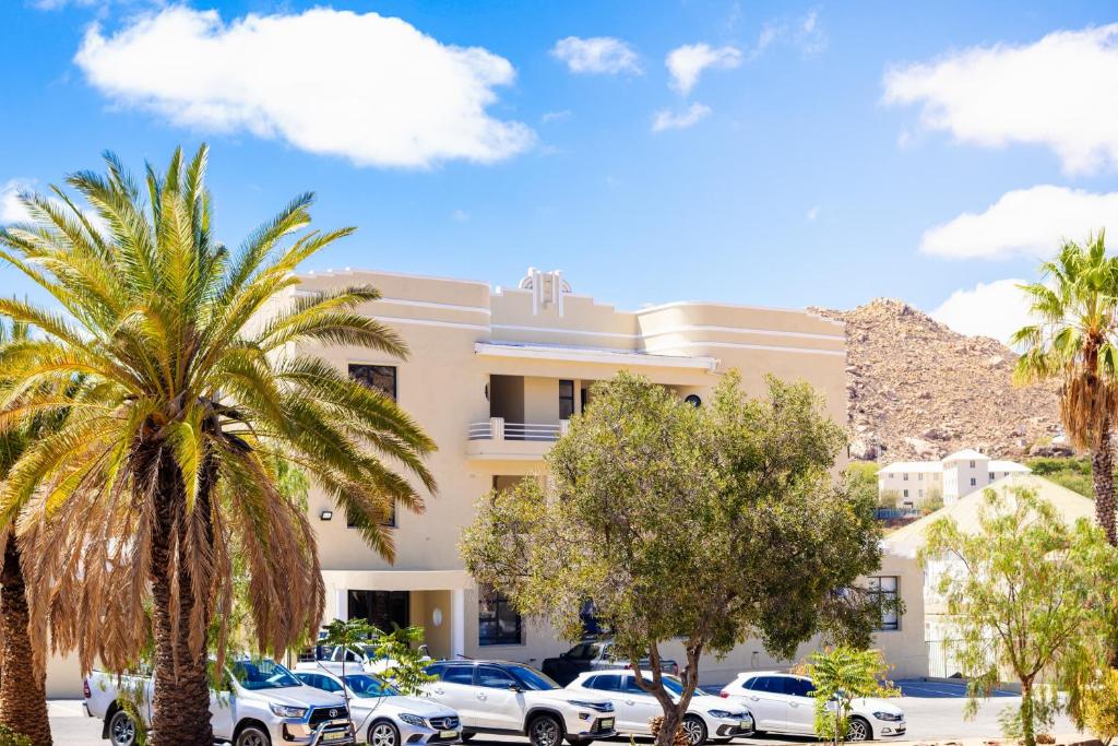 a building with cars parked in front of it at Galenia Boutique Hotel in Springbok
