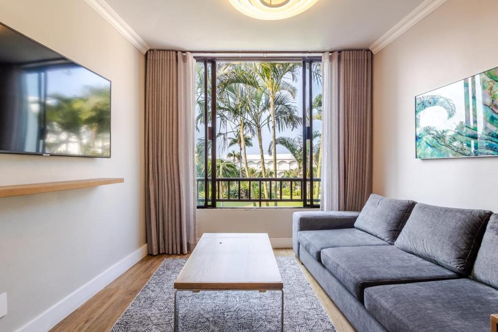 a living room with a couch and a window at Breakers Resort 316 Umhlanga in Durban