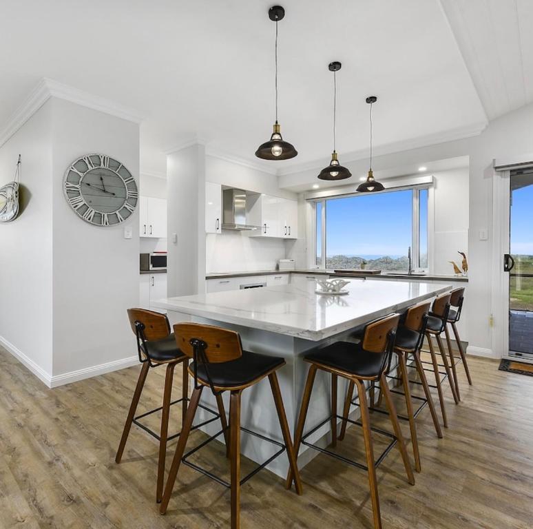 a kitchen with a large white table and chairs at Luxurious Home on the Beachside in Port MacDonnell