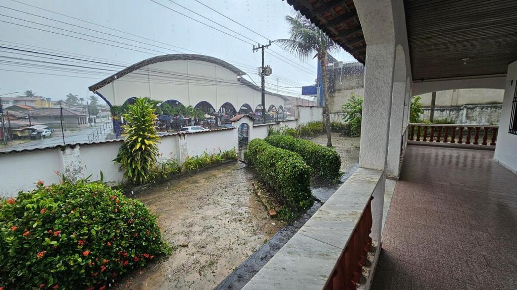 a balcony of a building with bushes and trees at Casa em Salinas in Salinópolis