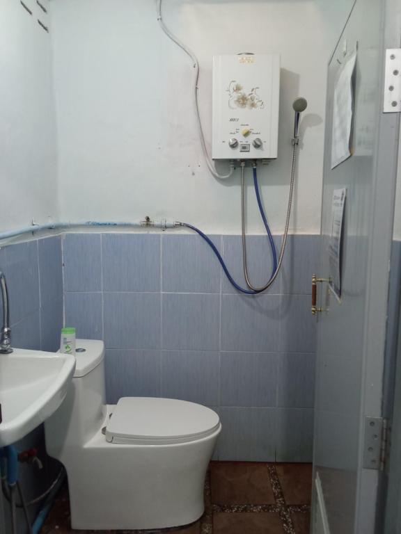 a bathroom with a white toilet and a sink at Mr Deang shop Doi Inthanon bird center in Ban Na Yang
