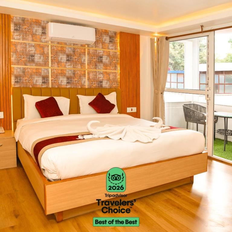 a bedroom with a bed in a room with a window at Hotel Elegant Kathmandu Inn- Heritage & Comfort Hotel in Kathmandu