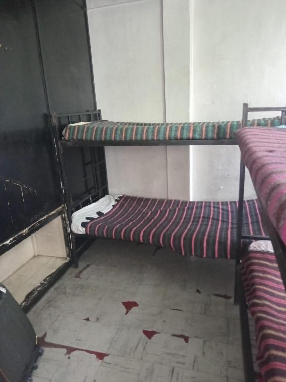 a room with two bunk beds in a room at Kioneki Hostel in Nairobi