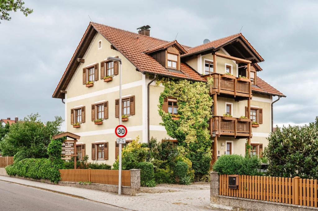 a large white house with a brown roof at Gäste-Haus Rösch in Wiesent