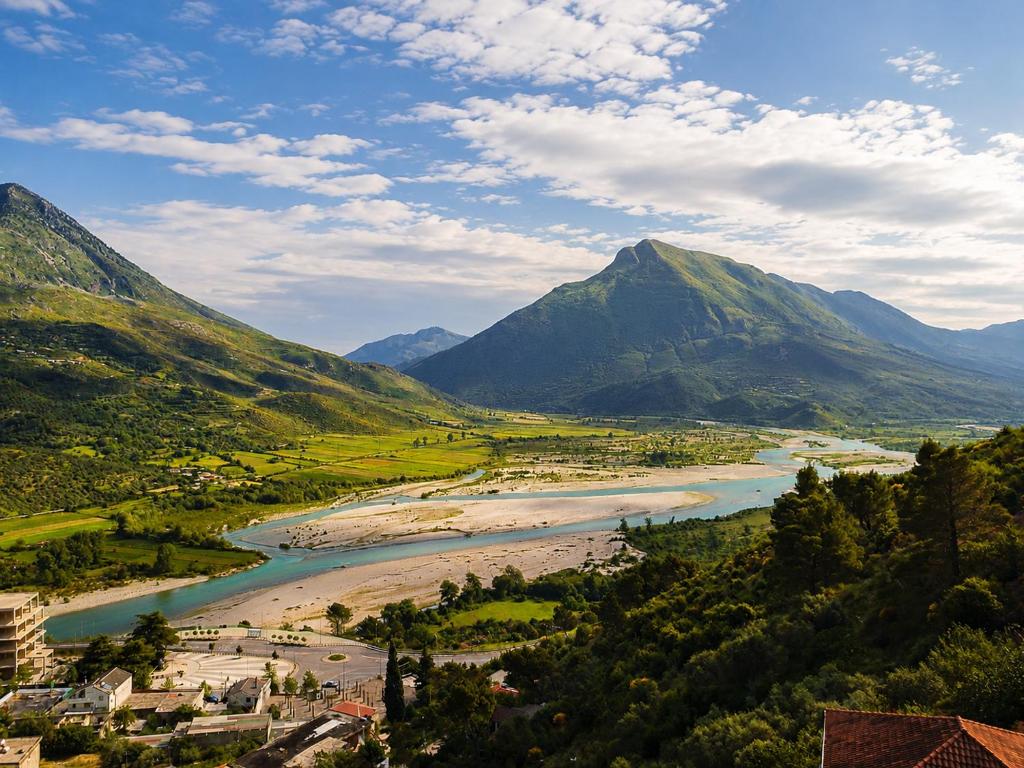 a view of a river with mountains in the background at Vila Përmbi Tepelenë in Tepelenë