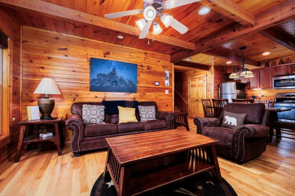 a living room with a couch and a table at Evening Star in Gatlinburg
