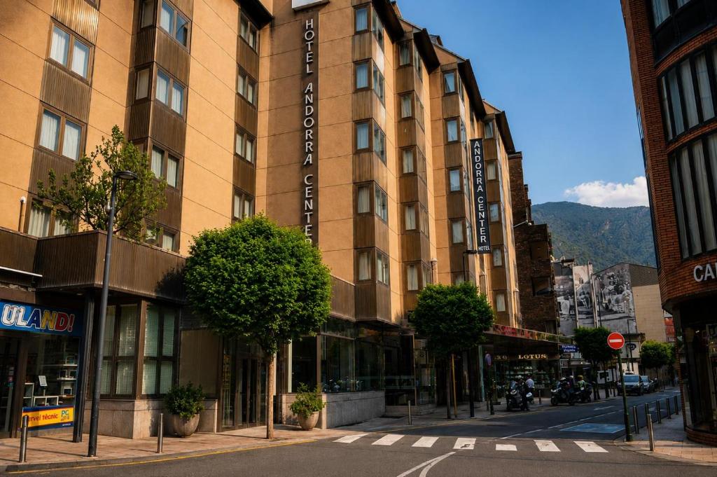 a building on a city street with trees in front of it at Hotel Best Andorra Center in Andorra la Vella