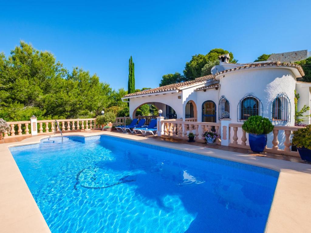 a swimming pool in front of a house at Holiday Home Mirada al Sol by Interhome in Moraira