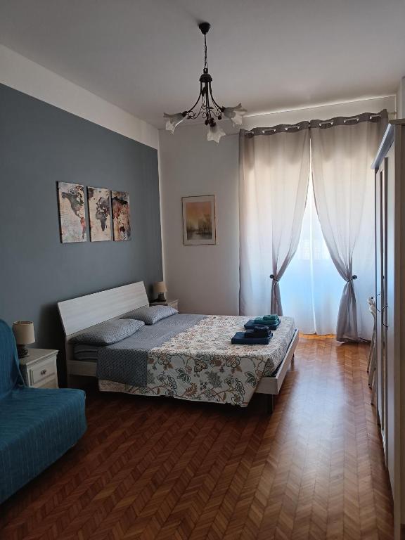 a bedroom with a bed and a large window at Il Papavero Nero in Rome