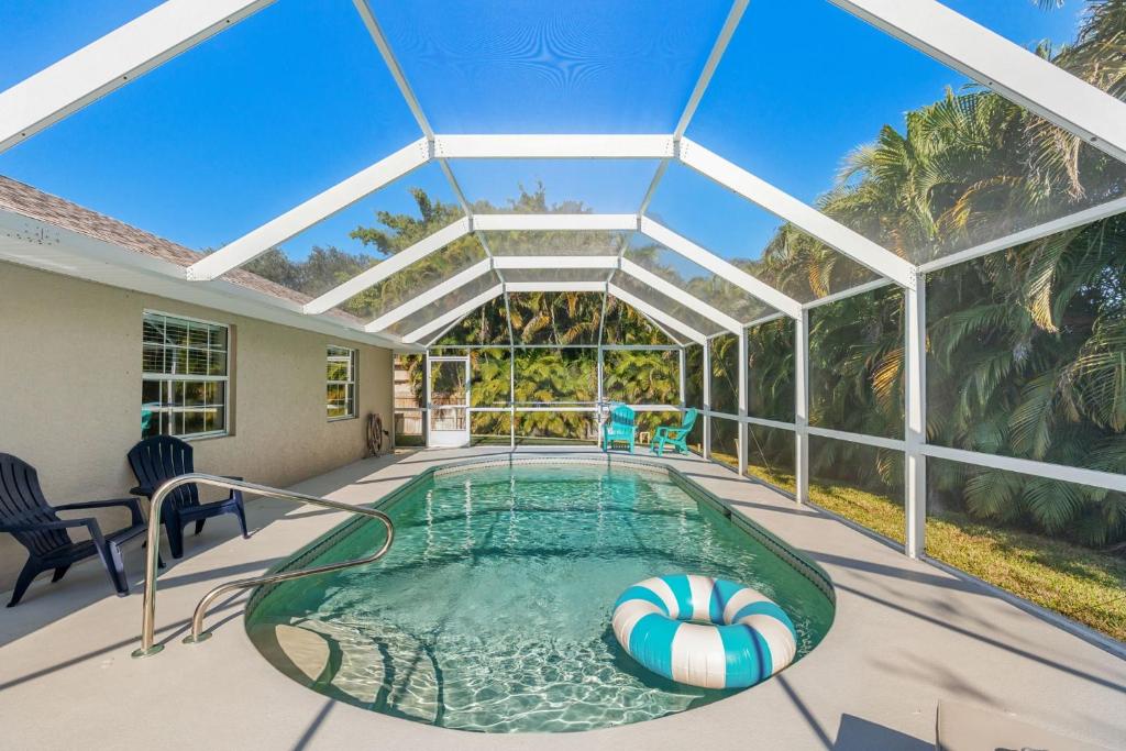 an indoor swimming pool with a glass ceiling at Paradise Vacay in Sebastian