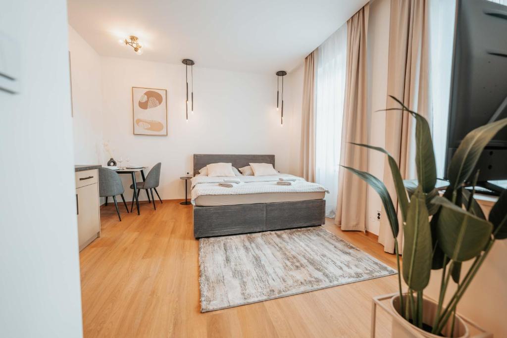 a bedroom with a bed and a table at CityBeat Apartments, 400m from the square in Pilsen