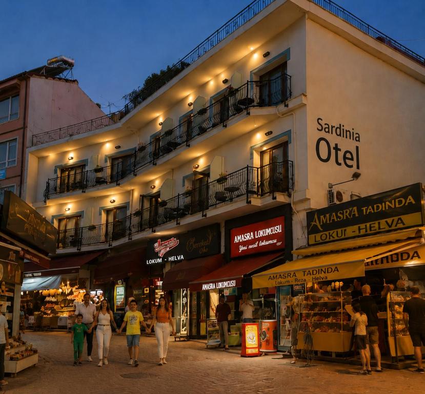 a group of people walking in front of a building at Sardinia Otel in Amasra