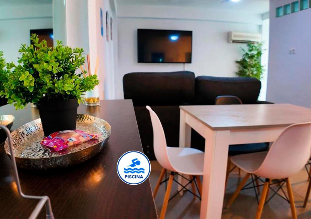 a dining room with a table and a table and chairs at Apartalux Vera Rincón de Loix in Benidorm