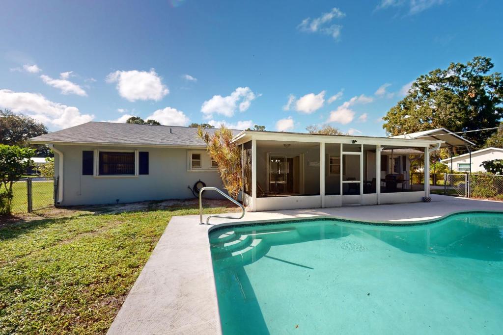a house with a swimming pool in front of a house at Serenity House - 1006 Ave 26th in Vero Beach
