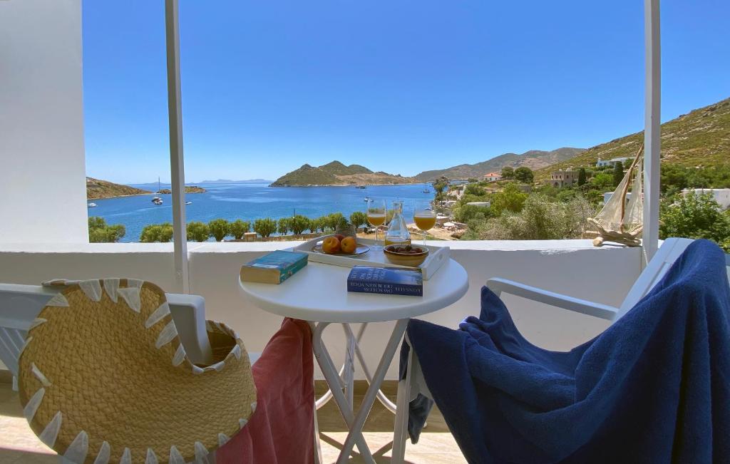a table and chairs with a view of the ocean at Apolafsis Studios in Patmos
