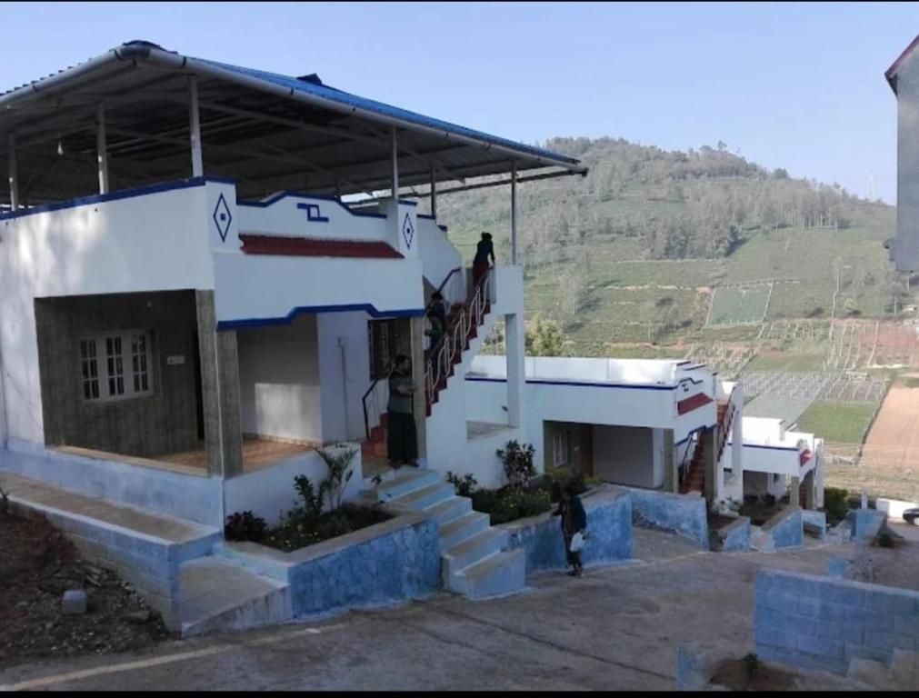a building with a staircase in front of it at VS valley view resorts in Kotagiri