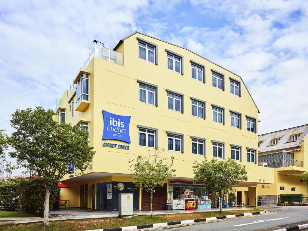 a yellow building with a sign on it at ibis budget Singapore Mount Faber in Singapore
