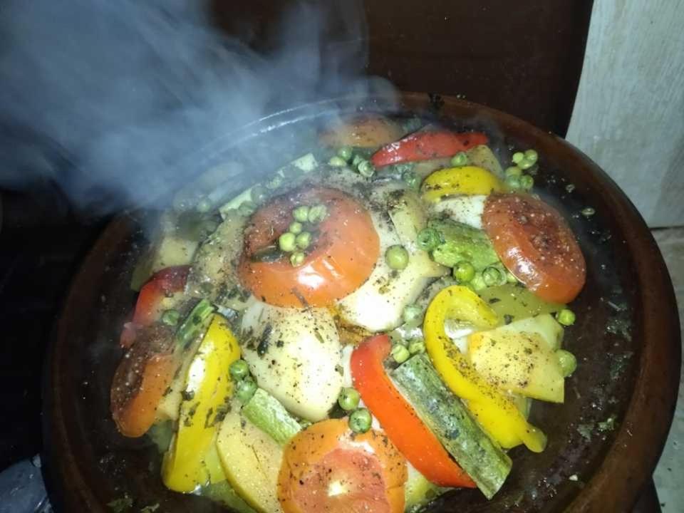 a bowl of food with tomatoes and other vegetables at Gite Oussalem timichi in Timichchi