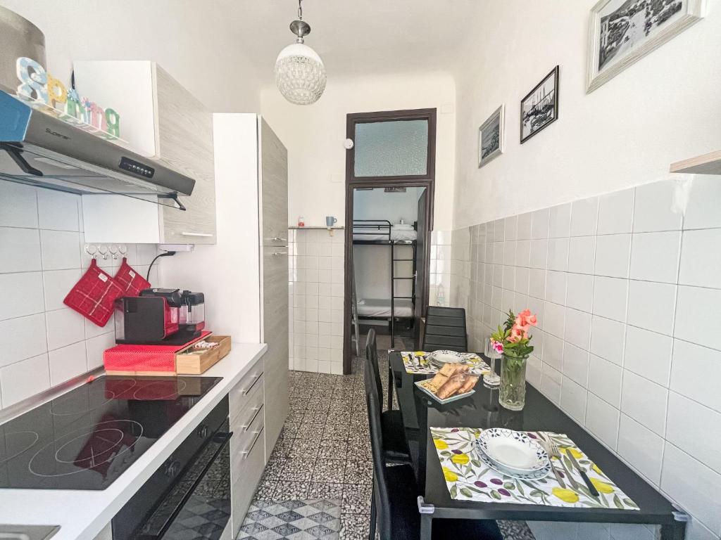 a small kitchen with a table and a counter top at Apartment casa JS by Interhome in Imperia