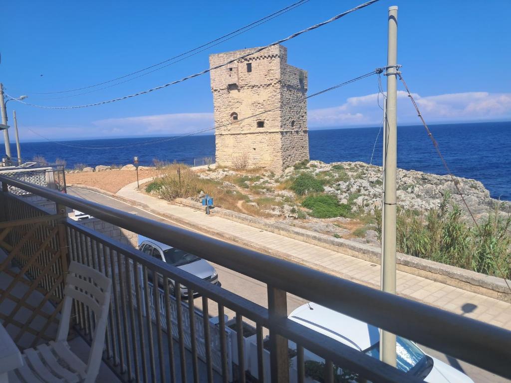 a balcony with a view of the ocean and a castle at Marina Serra in Marina Serra