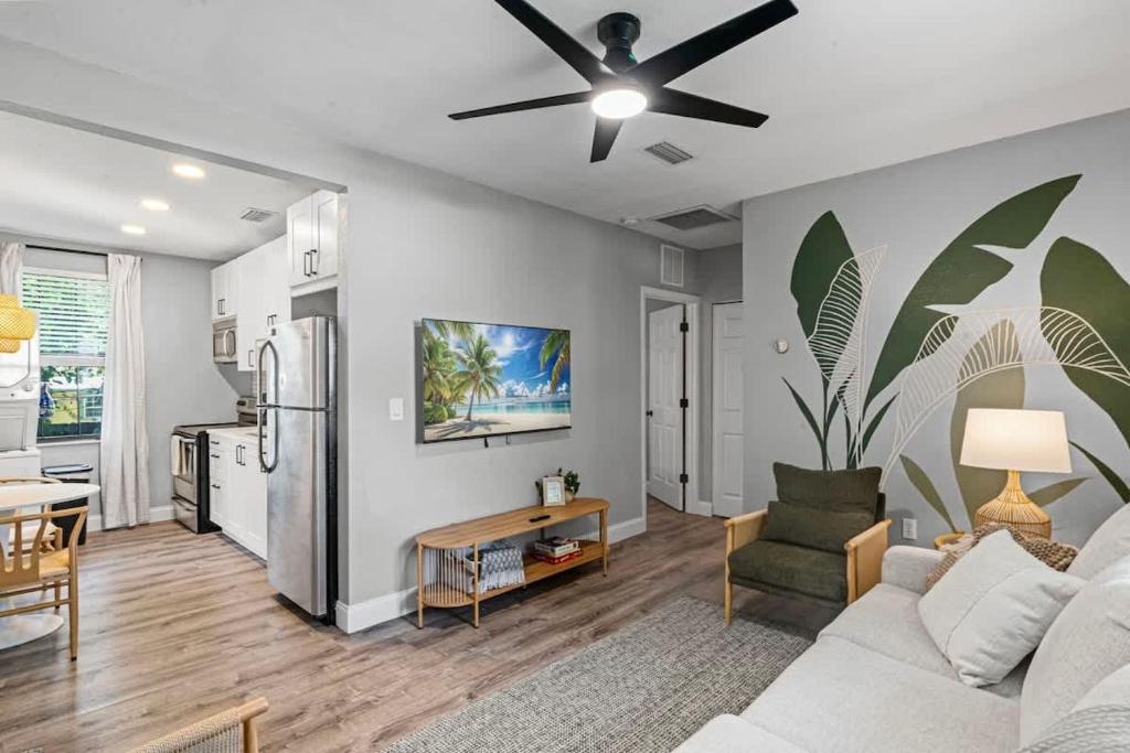 a living room with a couch and a kitchen at The Cedar Loft B - Team Joseph Ellen in St. Augustine