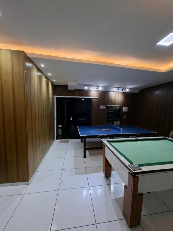 a room with two ping pong tables in it at Hotel e Pousada REQUINTTE in Parnaíba