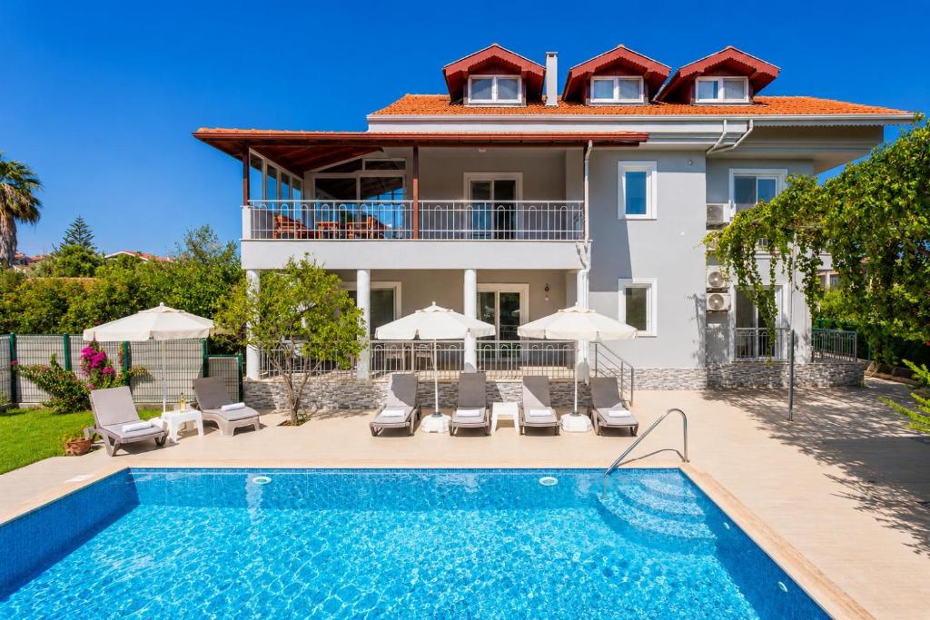 a villa with a swimming pool and a house at Daisy Villa in Dalyan
