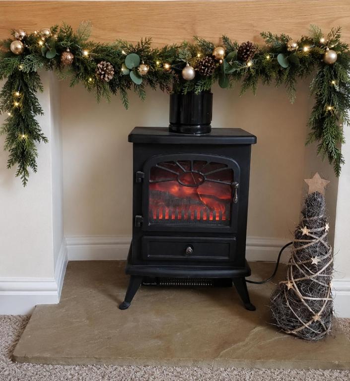 a fireplace with a christmasreath and a stove at York city centre No7 Agar Street in York