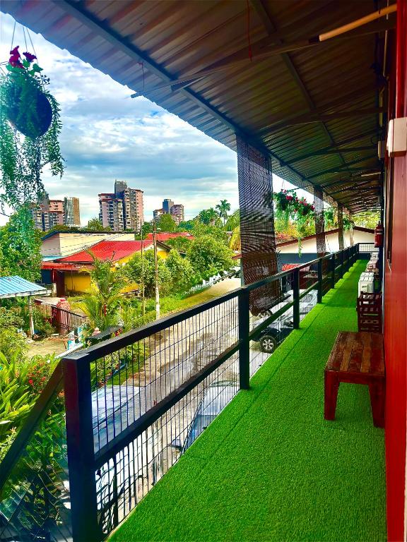 a balcony with green grass and a view of a city at Ummi Studio Homestay in Bayan Lepas