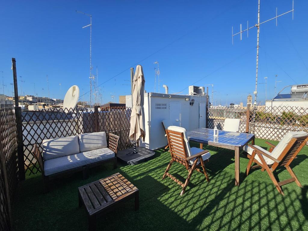 a patio with a table and chairs and a couch at BARI SOUL old town in Bari