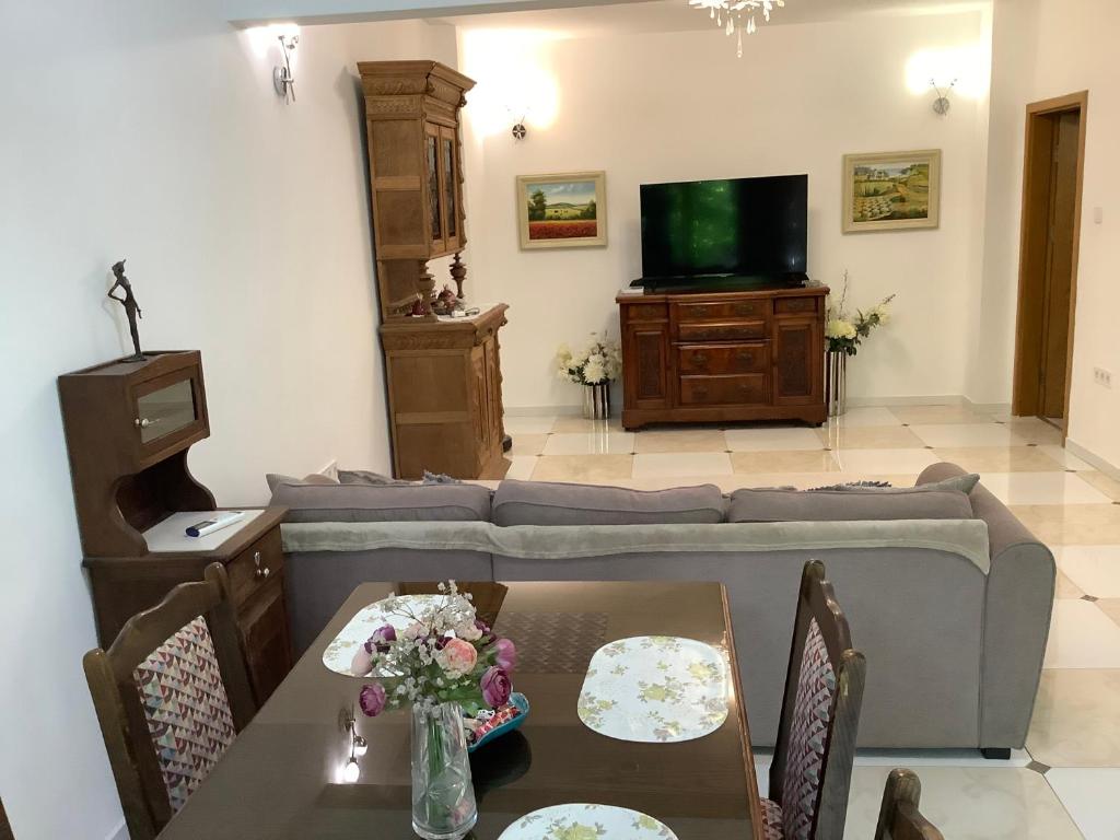 a living room with a couch and a tv at Kussmann Appartment in Varna City