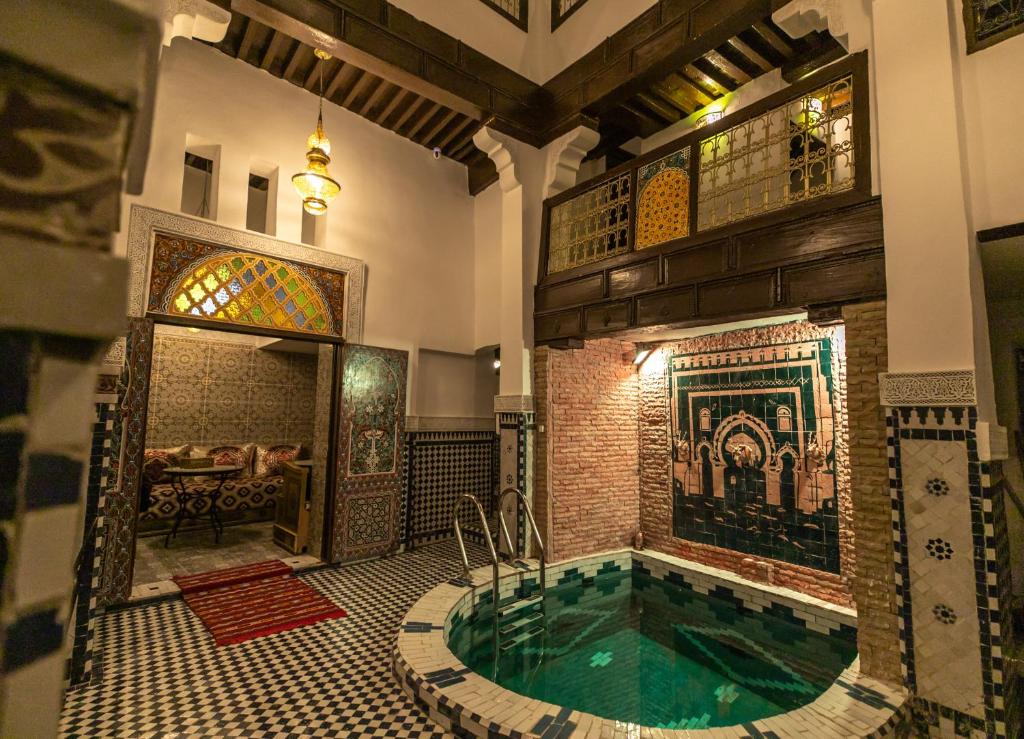 a large bathroom with a tub in a building at Riad Lile Fes in Fez