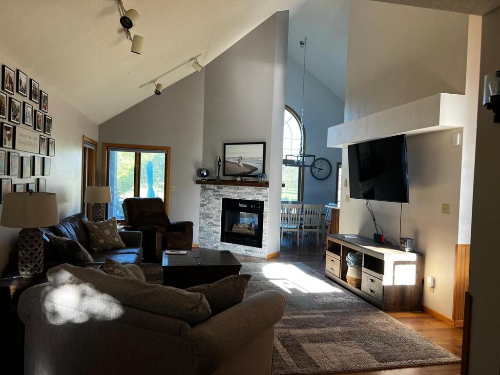 a living room with a couch and a fireplace at The Fairway Escape in Hayward