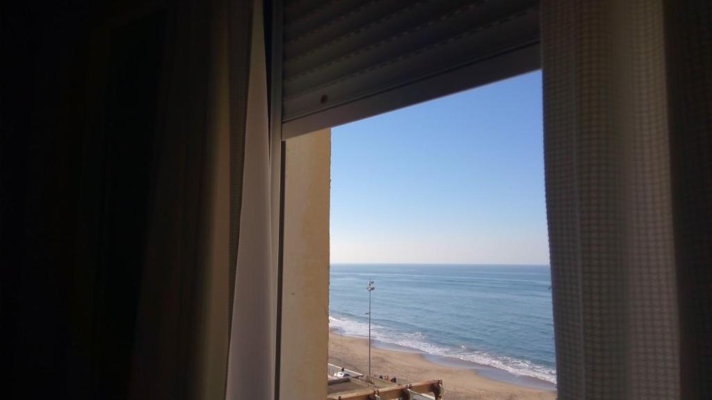 a view of the ocean from a window at Casita Coqueta Free Parking in Cádiz