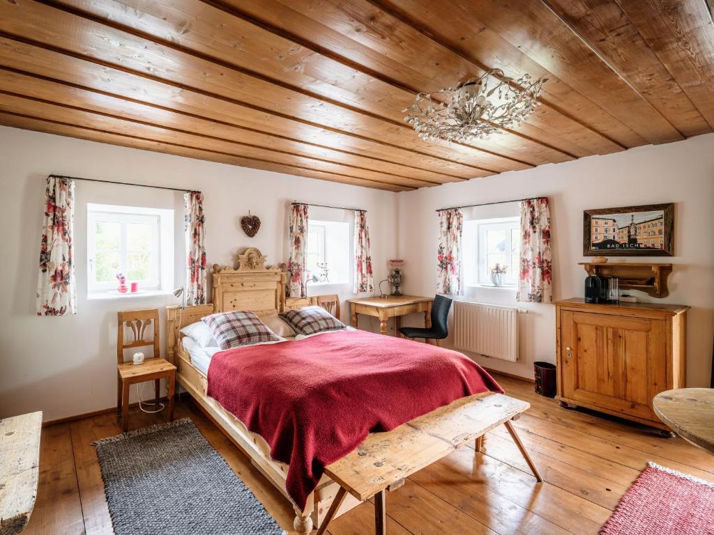 a bedroom with a bed and a wooden ceiling at Landlust Ischl in Bad Ischl
