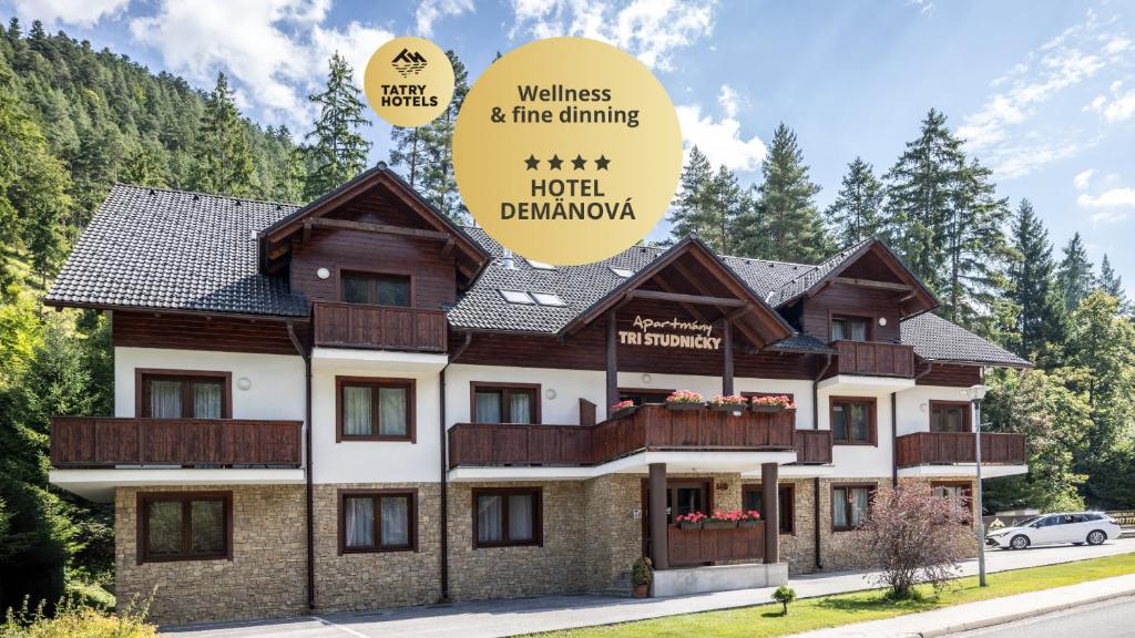 a building with a sign that reads wellness fire climbing hotel dharma at Apartmány Tri Studničky in Belá
