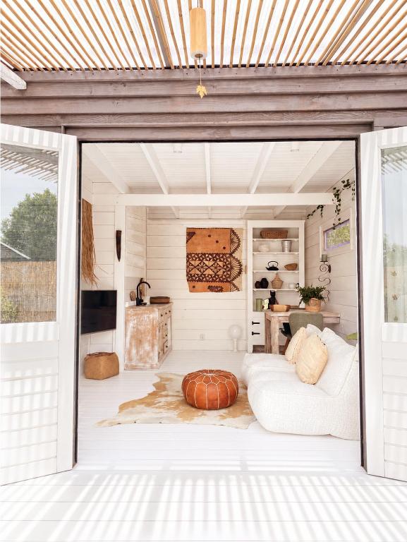 a living room with a couch and a table at Beach HideAway in Noordwijkerhout