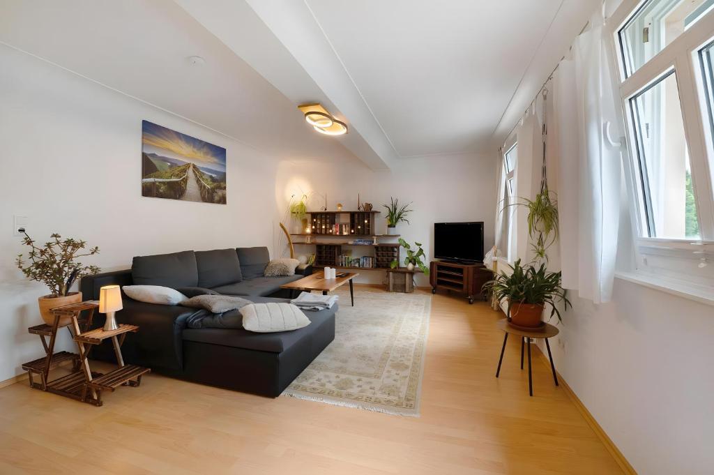 a living room with a couch and a table at Ferienwohnung Sensweiler Mühle in Sensweiler