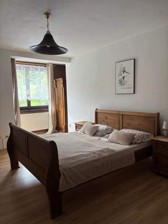 a bedroom with a large bed and a window at Zajazd pod Chmurką in Rabka-Zdrój