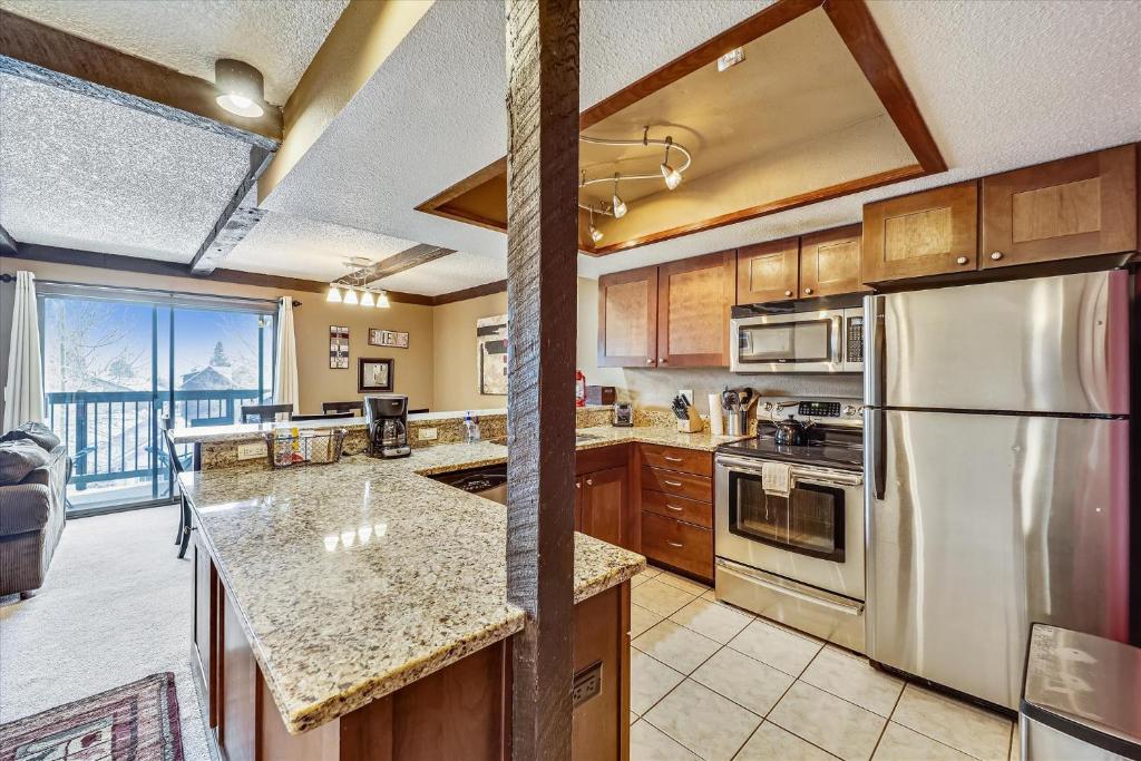 a kitchen with stainless steel appliances and a large window at Longbranch 214 in Breckenridge