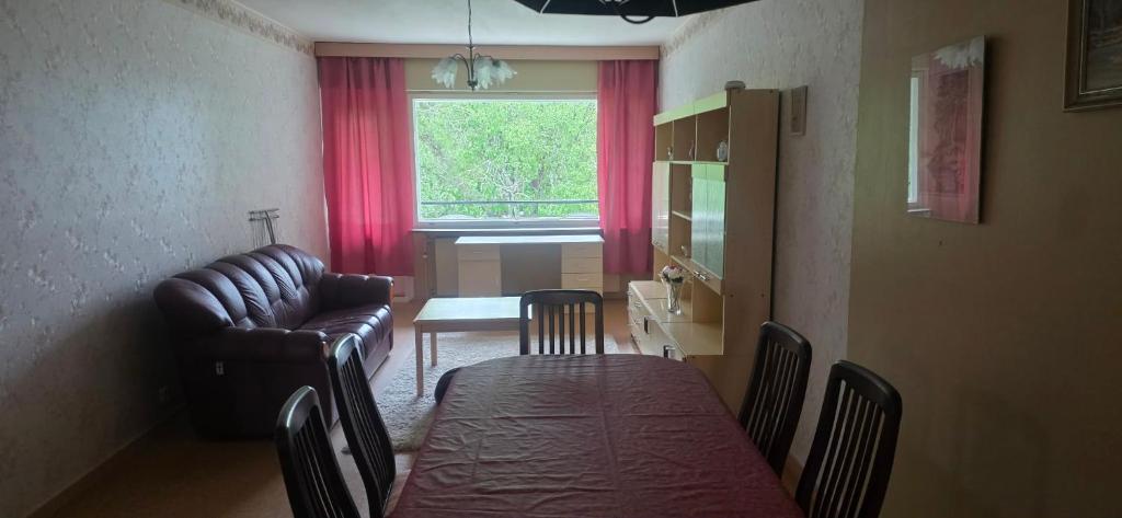 a living room with a couch and a dining room table at Pankkikallio 8 in Sorsakoski