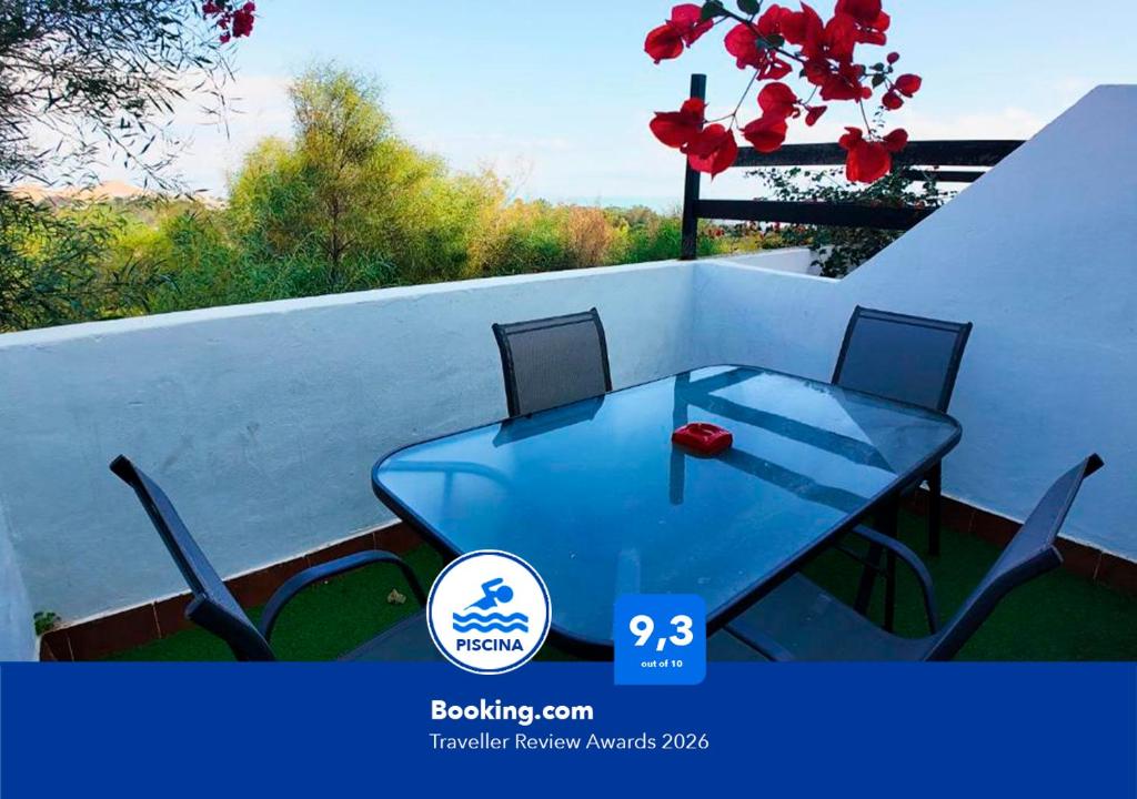 a blue table and chairs on a balcony at Apartalux Diamond Oasis in Mojácar