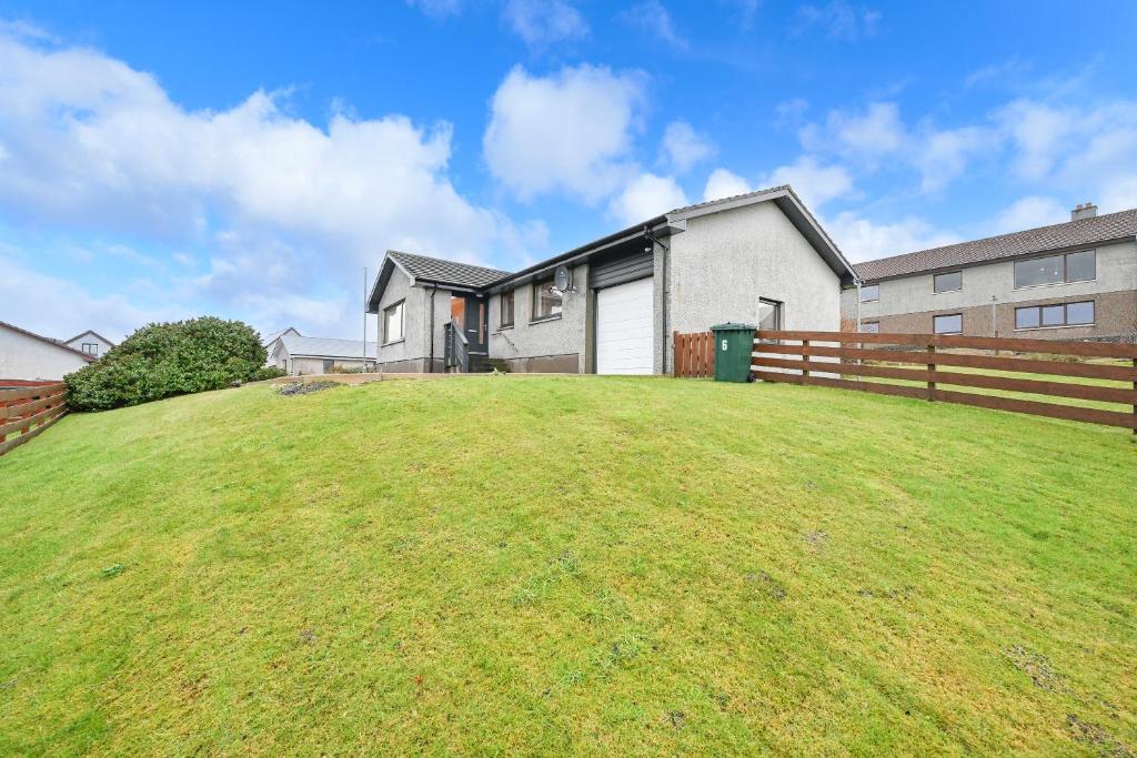 a large grassy yard in front of a house at Soundview in Lerwick