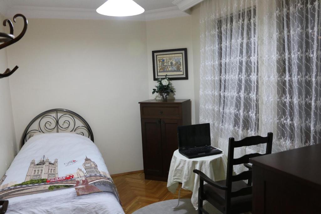 a bedroom with a bed and a laptop on a table at Best Room in Town in Karakusunlar Köyü