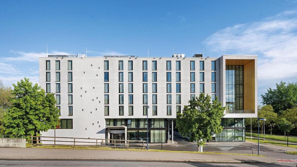 a large white building with a lot of windows at Hey Lou Hotel Friedrichshafen in Friedrichshafen