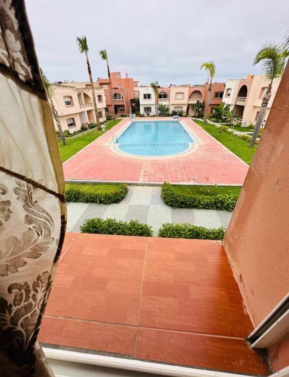 a view of a swimming pool from a building at Beautiful Duplex in secure residence with 2 pools in Sidi Bouzid